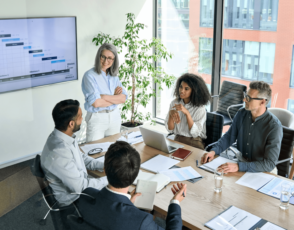 Sales team manager coaching reps during a performance review meeting