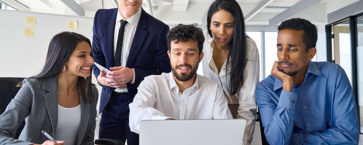Sales team discussing a structured sales training approach during a meeting.