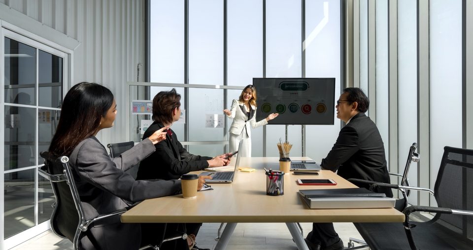 Sales team in an in-house training session discussing live sales conversations.